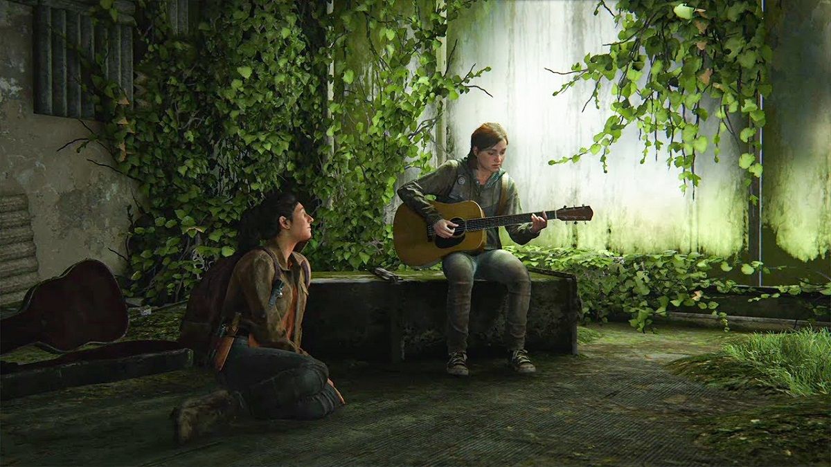 Dina (left) listens to Ellie (right) play a song for her on guitar in an empty, overgrown room in an old record store in the last of us part 2. Dina is a white Jewish young woman who's sitting on the floor looking up at Ellie. She has black hair in a ponytail, wears a brown jacket, backpack, jeans, and hiking boots. Ellie is seated on an overturned shelf and has chin-length brown hair half up in a pony tail, and a grey hoodie, jeans, and black and white Converse. 