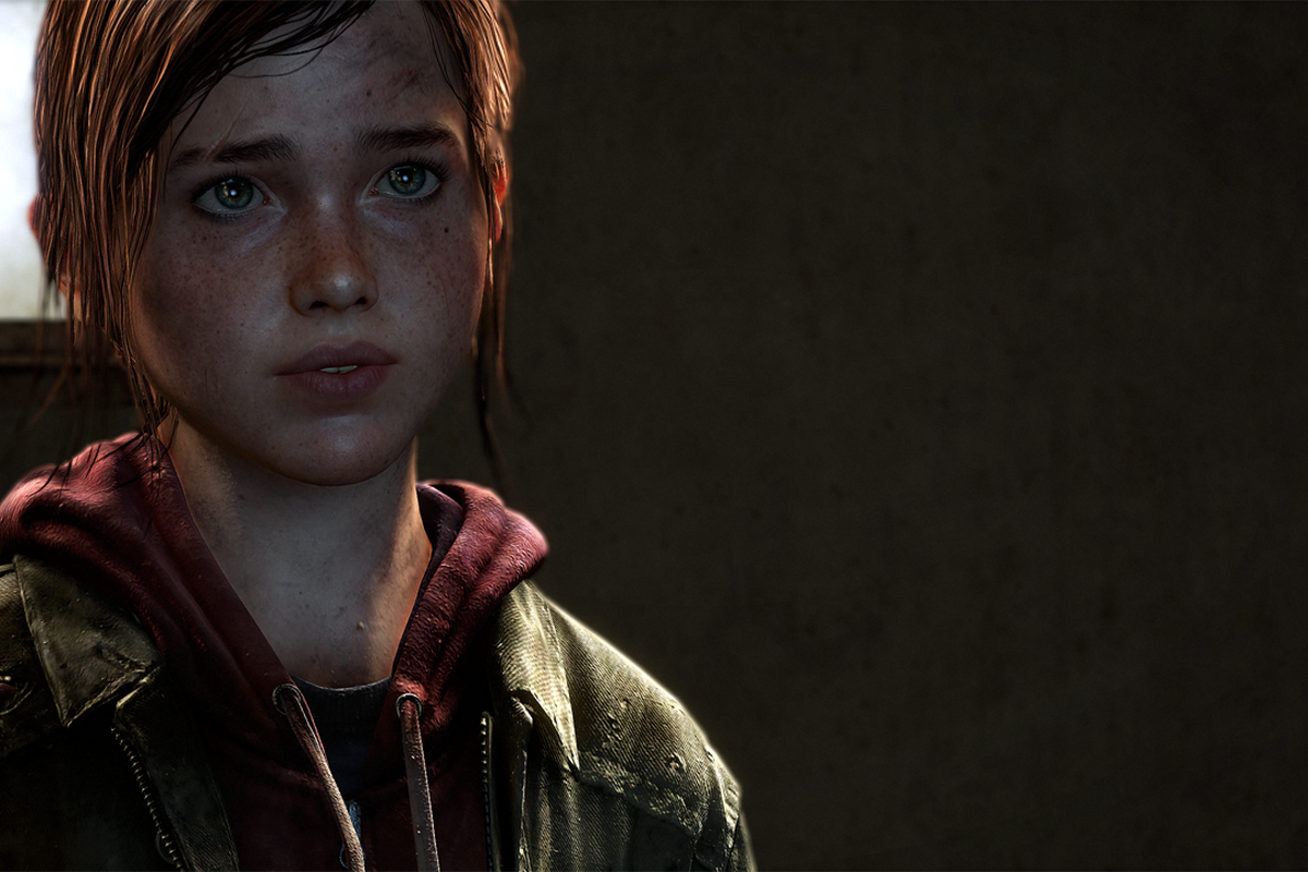 Close-up of Ellie in the video game 'The Last of Us' (2013). She is a white teenage girl with long brown hair in a ponytail. She's wearing a red hoodie under a green jacket. She has lots of freckles on her face and green/hazel eyes.