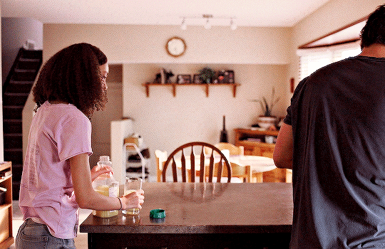 Sarah (Nico Parker) and Joel (Pedro Pascal) in a scene from HBO's 'The Last of Us. Sarah tries to hand Joel orange juice but he's already drinking coffee. 