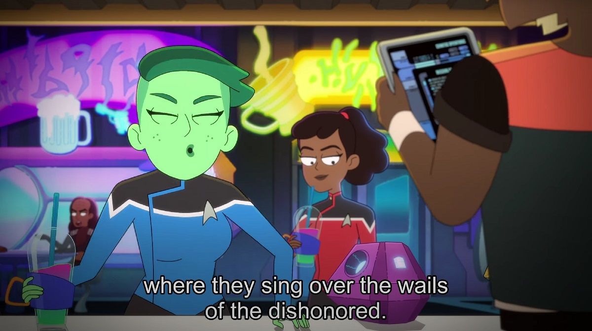 Tendi (left) and Mariner (right) enjoy Klingon Acid Punk on 'Star Trek: Lower Decks.' Tendi is an Orion with green skin and short, green hair. She's wearing a blue Starfleet uniform, and is standing at a drink kiosk enthusing about the music. Beckett, a Black human woman stands behind her smiling as she drinks her drink. The text at the bottom of the image reads "where they sing over the wails of the dishonored."