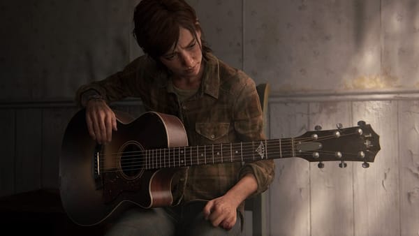 Ellie is a young white woman with chin-length brown hair. She wears a plaid buttondown and jeans and has a guitar on her lap.