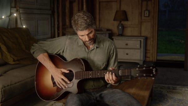 Joel in a scene from 'The Last of Us, Part II' (2020). He's sitting on a coffee table playing guitar.